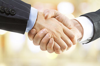 human handshake on a blured yellow  background